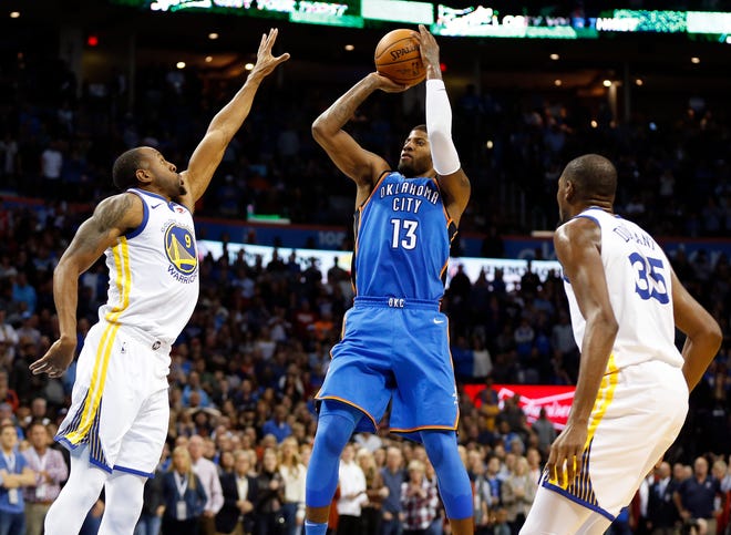 Oklahoma City's Paul George (13) shoots between Golden State's Andre Iguodala (9), left, and Golden State's Kevin Durant (35) in the second quarter during an NBA basketball game between the Oklahoma City Thunder and the Golden State Warriors at Chesapeake Energy Arena, Wednesday, Nov. 22, 2017. Photo by Nate Billings, The Oklahoman