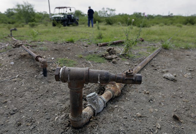 Parts of a deserted injection well sit idle on a South Texas ranch near Bigfoot, Texas. [ERIC GAY/AP FILE PHOTO]