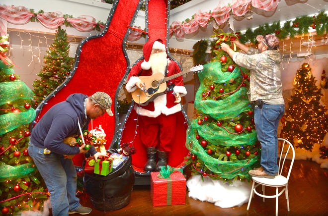 Eric Ray, left, and Miguel Debora prepare displays inside Christmas Winter Wonderland, 7300 Wells Lake Road, on Wednesday, Nov. 22, 2017. The 20,000 square foot indoor walk-through Christmas attraction will open Dec. 1. Attractions include Santa's Express Train rides, Rudolph's Forest, Santa's Workshop, stories with Mrs. Claus, pictures with Santa, a gift shop and bake shop. [BRIAN D. SANDERFORD/TIMES RECORD]