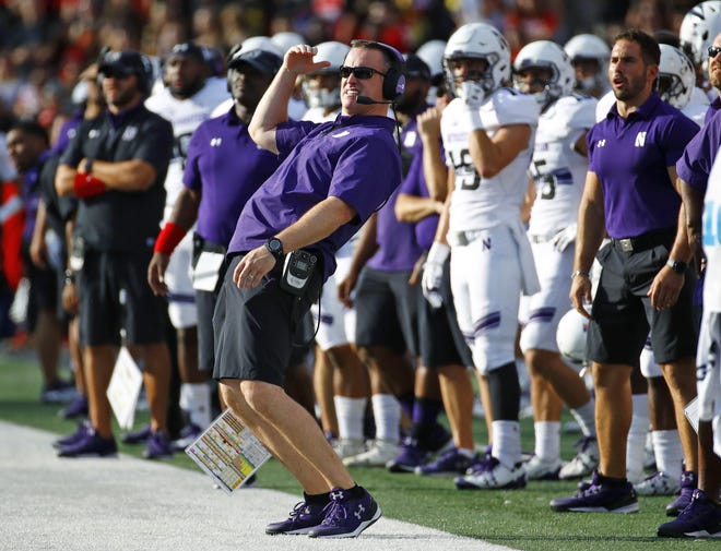 Northwestern coach Pat Fitzgerald, center, watches a field goal attempt by his team in a game earlier this season.[Patrick Semansky/The Associated Press]