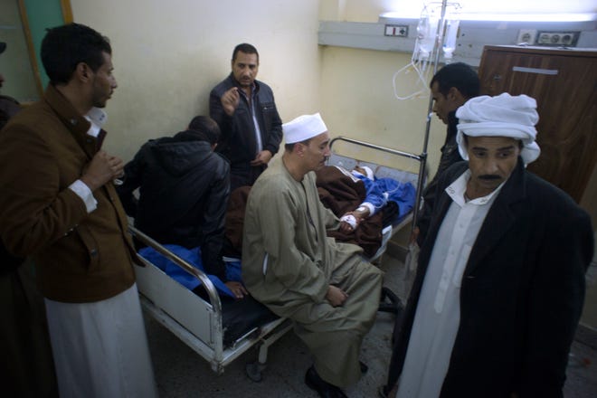 Relatives of Sheikh Sulieman Ghanem, 75, center, surround him as he receives medical treatment at Suez Canal University hospital in Ismailia, Egypt, Friday, Nov. 24, 2017, after he was injured during an attack on a mosque. Militants attacked a crowded mosque during Friday prayers in the Sinai Peninsula, setting off explosives, spraying worshippers with gunfire and killing more than 200 people in the deadliest ever attack by Islamic extremists in Egypt. (AP Photo/Amr Nabil)