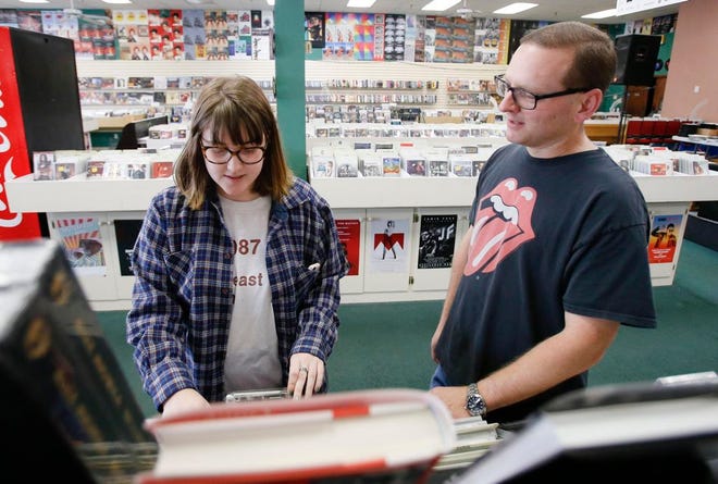 Jason Patton, right, talks with Anna Rahkonen about the release of Taylor Swift's newest album that will also be available as a vinyl at Oz Music in the Parkvew Plaza shopping center on Monday, Nov. 20, 2017. [Staff Photo/Erin Nelson]