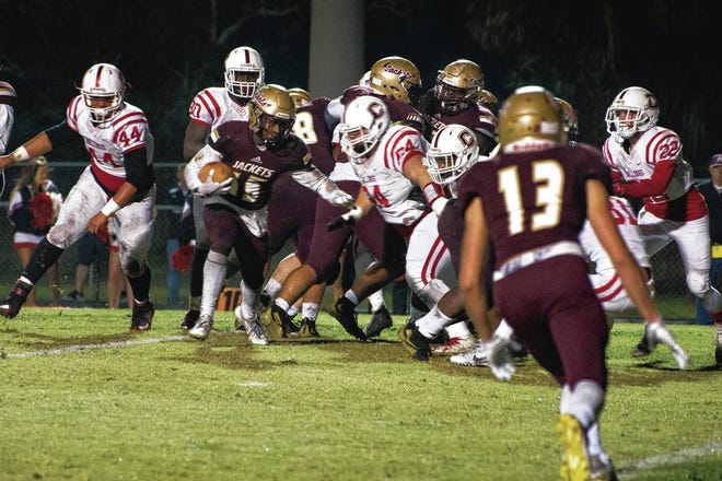 St. Augustine High School running back Dexter Brown pushes through Crestview defensive players in a home region final game on Friday, November 24, 2017. (Christina Kelso, St. Augustine Record)