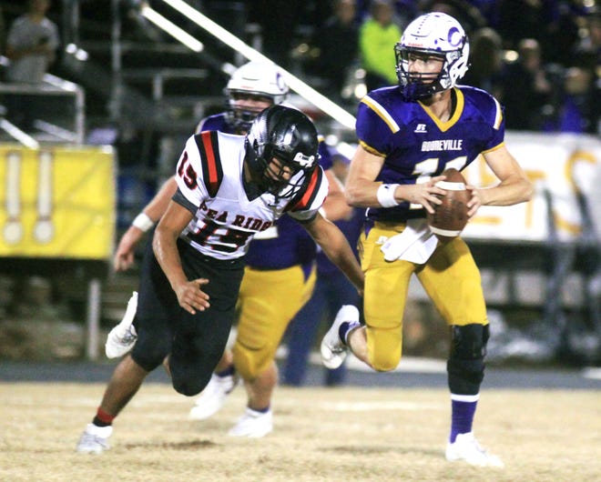 Booneville quarterback Brandon Ulmer scrambles as Pea Ridge defender Luis Reyes pursues on Friday, Nov. 24, 2017, at Booneville. [AARON SHAFFER/SPECIAL TO THE TIMES RECORD]