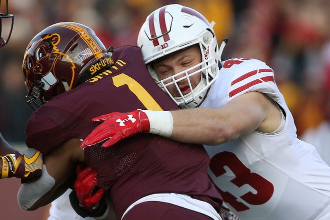 Wisconsin inside linebacker Ryan Connelly (43) tackles Minnesota running back Rodney Smith (1) during an NCAA college football game Saturday, Nov. 25, 2017, in Minneapolis. Wisconsin won 31-0. (AP Photo/Stacy Bengs)