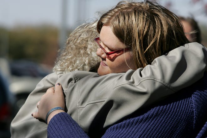 Heidi Mackey (right) gets a hug from Heidi Korf after Mackay shared her personal story of living with mental illness during a Rally for Mental Health held in October 2012 outside the Winnebago County Justice Center in Rockford, Illinois.

[AMY J. CORRENTI/ROCKFORD REGISTER STAR]