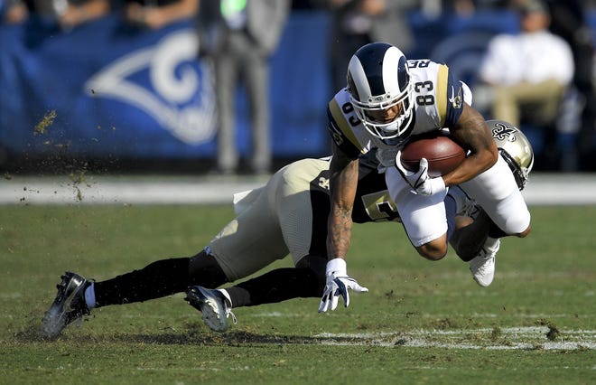 Los Angeles Rams wide receiver Josh Reynolds is tackled by New Orleans Saints cornerback De'Vante Harris on Sunday. Reynolds caught a touchdown pass in the Rams' 26-20 victory. [AP Photo/Mark J. Terrill]