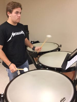 Bishop McGuinness student Pierce Wilkins plays the timpani. A $19,000 grant provided for the purchase of a four-piece timpani set, a marimba and a clavinova. [PHOTO PROVIDED]