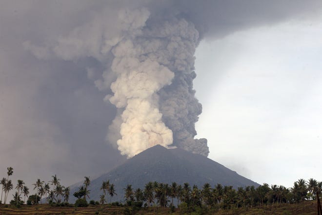 A view of the Mount Agung volcano erupting in Karangasem, Bali, Indonesia, Monday, Nov. 27, 2017. The volcano on the Indonesian tourist island of Bali erupted for the second time in a week on Saturday, disrupting international flights even as authorities said the island remains safe. (AP Photo/Firdia Lisnawati