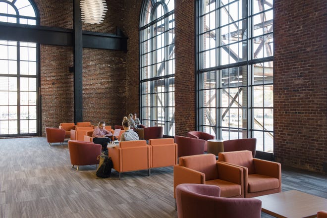 A lounge in a public nursing school housed in a former power station in the innovation district of Providence, R.I., on Oct. 30. Lined with 30-foot arched windows, the brick building provided vast views of the river and the city beyond. [The New York Times / Rachel Hulin]