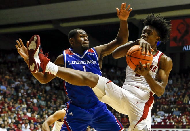 Alabama guard Collin Sexton (2) rebounds the ball away from Louisiana Tech guard Derric Jean in the first half of the No. 24 Crimson Tide's 77-74 victory Wednesday. [Butch Dill/The Associated Press]