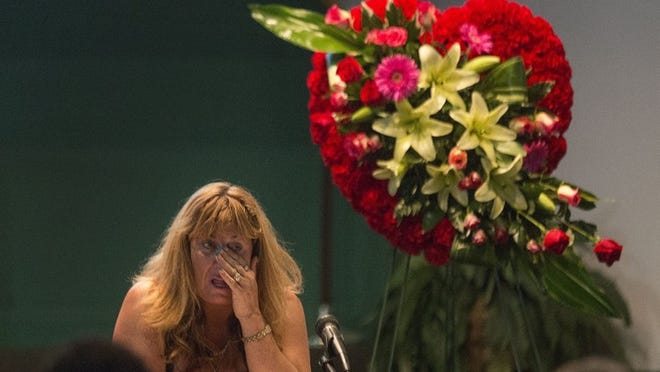 Laura Lee Chapman, the owner of LL&R’s Stepping Stones sober living facility, wipes tears from her eyes during a memorial June 29, 2014 at Fern House for her friend, Margeaux Greenwald, whose body was found in Palm Beach Gardens on June 7. Friends and co-workers came out to comfort and encourage one another, sing songs, watch a slideshow, and share a meal during the ceremony. (Damon Higgins / The Palm Beach Post)