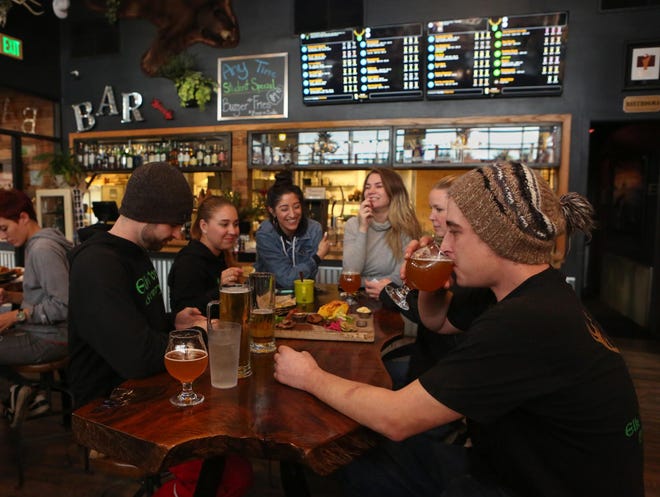 Staff and customers at Elk Horn Brewery & Ciderhouse in Eugene. (Kelly Lyon/The Register-Guard)