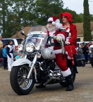 Santa and Mrs. Claus ride a motorcycle in the 2016 Lynn Haven Christmas Parade. This year's parade starts at 10 a.m. Saturday at A.L. Kinsaul Park. [NEWS HERALD FILE PHOTO]