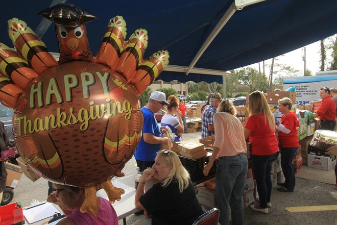 A festive turkey ballon floats above a army of volunteers at the Jewish Federation of Volusia and Flagler Counties, Tuesday, Nov. 21, 2017, as the federation gives out 400 turkey dinners for Thanksgiving.  [News-Journal/David Tucker]