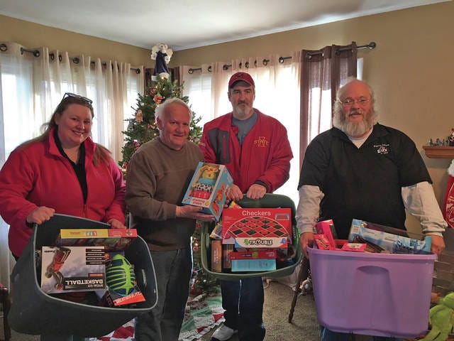 (Left to right) Amber Green, Perry Lodge Esquire; John Andorf; Eric Derry, Perry Lodge Member; Dave Davis, Perry Lodge Leading Knight. Andorf collected toys for the Toys for Tots program from the Perry Elks Club. Also in attendance was Davis’ wife Patti. PHOTO BY LISA WIDICK/THE PERRY CHIEF