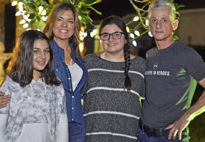 Sophia Helme, center, with her family, sister Gianna Helme, 12, mom Andrea and dad John Helme. Sophia, 18, is taking classes at State College of Florida, but hopes to attend Florida Gulf Coast University in Fort Myers. A diabetic alert dog could help her live more independently. 

[Herald-Tribune staff photo / Thomas Bender]