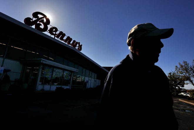 Long-time shopper Robert Cingolani leaves the Benny's on Dartmouth Street for the last time as the sun sets on the local icon in October. 

[ PETER PEREIRA/THE STANDARD-TIMES FILE/SCMG ]