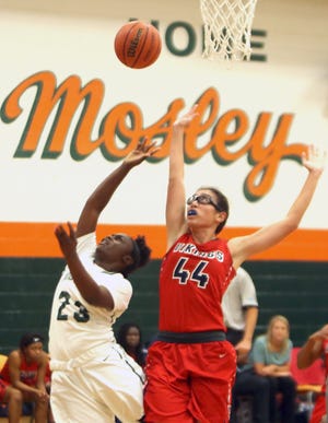 Mosley’s J’Tayvia Holley (23) drives inside against Jamielya Jarvis of Fort Walton Beach in the Dolphins’ 57-49 loss Thursday. [PATTI BLAKE/THE NEWS HERALD]