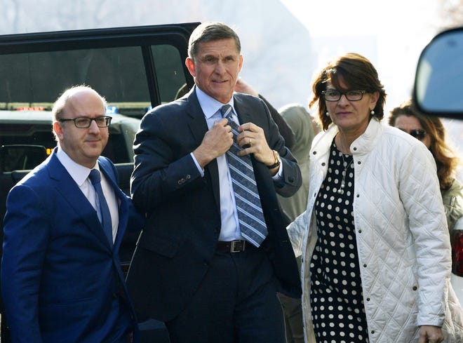Former Trump national security adviser Michael Flynn, center, arrives at federal court in Washington, Friday, Dec. 1, 2017. Court documents show Flynn, an early and vocal supporter on the campaign trail of President Donald Trump whose business dealings and foreign interactions made him a central focus of Mueller's investigation, will admit to lying about his conversations with Russia's ambassador to the United States during the transition period before Trump's inauguration. (AP Photo/Susan Walsh)