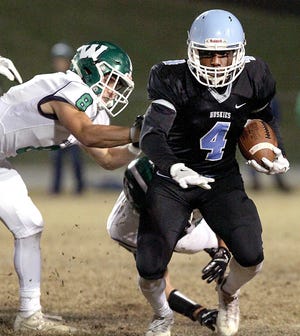 Crawford Chandler, of Hunter Huss, tries to break away from Weddington's Branson Mcgee during the playoff game Nov. 17 at Hunter Huss High School. Chandler was named to the Big South 3A all-conference first team. [JOHN CLARK/THE GASTON GAZETTE]