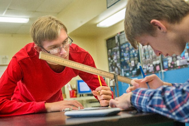 DAVID ZALAZNIK/JOURNAL STAR Jennings Rule, left, and his Richwoods High School physics lab partner, Gabe Carter, work Wednesday to establish equilibrium on a balanced ruler by adjusting forces and torques created by precise placement of added weights on the ruler. Rule achieved a perfect score of 36 on his ACT test.