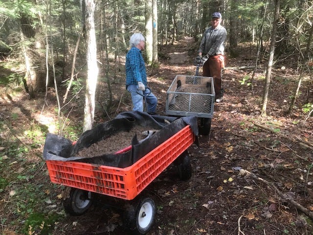 Hiawatha Shore-to-Shore (HSS) Roving Crew members Carol Wozniak of Sault Ste. Marie and Stan Kujawa of Rudyard help haul gravel while working on the Wolf Lake Project near Newberry. The Wolf Lake Project included several boardwalks and a 16 foot bridge in a 6 mile section of the North Country National Scenic Trail that doesn’t have access roads.
