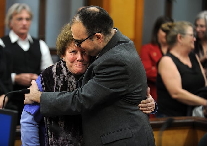 Louise Coleman, ex-director of Greyhound Friends dog rescue in Hopkinton, hugs her lawyer, Daniel Cappetta, after being found not guilty of animal cruelty charges on Friday.

[Daily News and Wicked Local Staff Photo/Allan Jung]