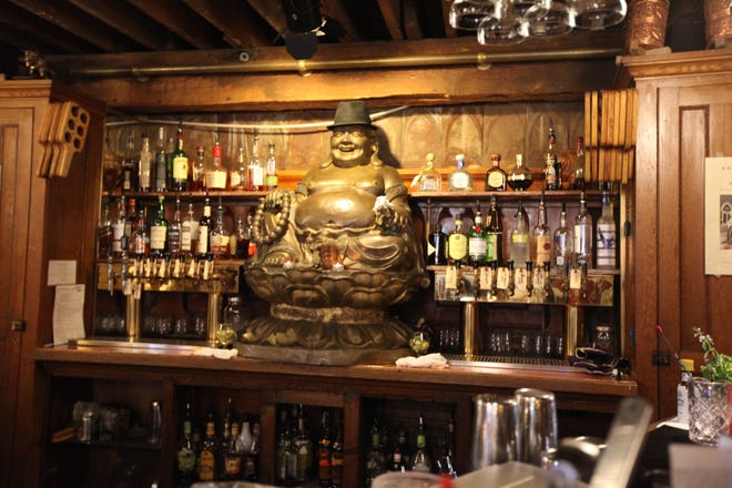 A happy Buddha watches over the bar at Father John's Brewing Company, Bryan, Ohio. [Steve Stephens]