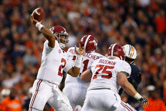FILE - In this Nov. 25, 2017, file photo, Alabama quarterback Jalen Hurts throws the ball during the second half of the Iron Bowl NCAA college football game, in Auburn, Ala. The Associated Press voters prefer Alabama over Ohio State. In the final Top 25 of the regular season, the Crimson Tide was No. 4 and the Buckeyes were No. 5. (AP Photo/Brynn Anderson, File)
