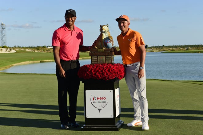 Rickie Fowler, right, poses with Tiger Woods and the trophy after Fowler won the Hero World Challenge golf tournament at Albany Golf Club in Nassau, Bahamas, Sunday, Dec. 3, 2017. (AP Photo/Dante Carrer)