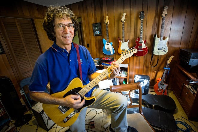 Dr. Daniel Leviten, founder of Lakeside Pediatrics, shows his Fender Telecaster in his home's guitar room. He is retiring this month after treating thousands of children over his decades-long career. [ ERNST PETERS/THE LEDGER  ]