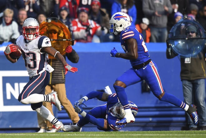 Patriots running back Dion Lewis (left) had 92 rushing yards as the run game helped the Patriots come out of Buffalo with a win on Sunday. [AP Photo/Rich Barnes]