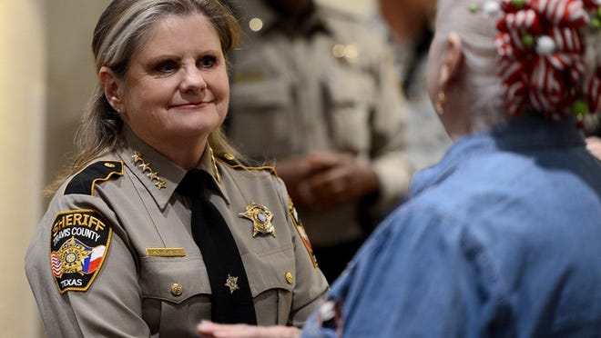 Travis County Sheriff Sally Hernandez speaks to a Wells Branch resident during a town hall meeting Tuesday night at the Wells Branch MUD Community Center. Photo by Mark Otte