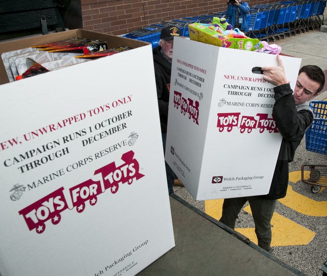 Dylan Vogel, 17, of Horsham loads another large box of toys filled with toys for the annual Toys for Tots drive at Toys R Us on Sunday, Dec. 3, 2017,in Horsham. Vogel has been volunteering since he was 5. [Rick Kintzel/photojournalist]