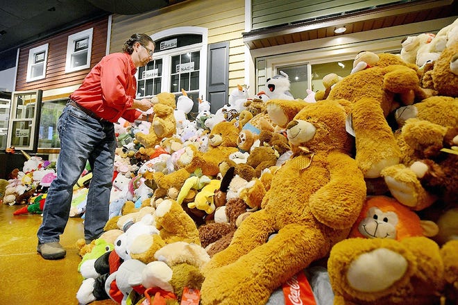 Scot Hayes puts thousands of stuffed animals collected through the Teddy Bear Toss on display in the New York Sash showroom in Whitesboro on Dec. 11, 2014. The event is now in its 13th year. [OBSERVER-DISPATCH FILE PHOTO]