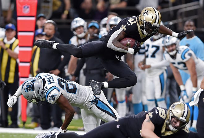 New Orleans Saints rookie running back Alvin Kamara (41) leaps over Carolina Panthers cornerback Daryl Worley (26) in the second half of their game in New Orleans Sunday. The Saints won 31-21. (AP Photo/Bill Feig)