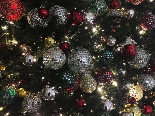 In this Friday, Dec. 1, 2017, photo, ornaments hang on a Christmas tree on display in New York. The office holiday party is getting shaken up as reports of sexual misconduct by famous and powerful men have many companies thinking harder about how to stop bad behavior in the workplace. A survey shows fewer companies will serve alcohol this year than last year, but HR experts say that’s not enough. (AP Photo/Swayne B. Hall)
