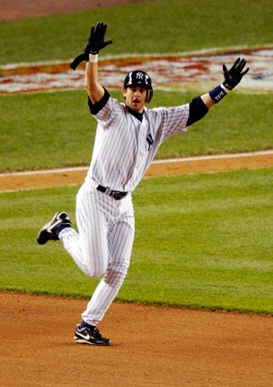 FILE - In this Oct. 16, 2003, file photo, New York Yankees' Aaron Boone celebrates his game-winning home run off Boston Red Sox pitcher Tim Wakefield during the 11th inning of Game 7 of the American League Championship Series in New York. A person familiar with the decision says the Yankees have picked ESPN broadcaster Boone to succeed Joe Girardi as manager. The person spoke on condition of anonymity Friday night, Dec. 1, 2017, because the decision had not been announced by the team. Now 44, Boone has never been a manager or even a coach at any level since retiring as a player after the 2009 season. (AP Photo/Bill Kostroun, File)