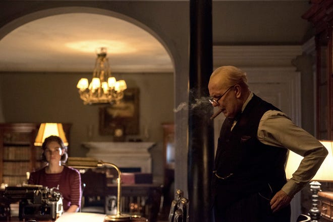 Winston Churchill (Gary Oldman) dictates a speech while Elizabeth (Lily James) types it up. [Focus Features]