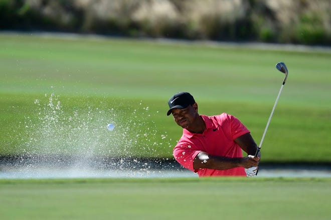 Tiger Woods hits from a bunker on the 17th hole during the final round of the Hero World Challenge golf tournament at Albany Golf Club in Nassau, Bahamas, Sunday, Dec. 3, 2017.