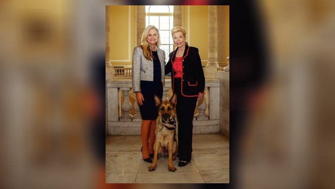 Dr. Robin Ganzert, president of American Humane, left, with Lois Pope and a German shepherd hero dog. Courtesy of American Humane Association