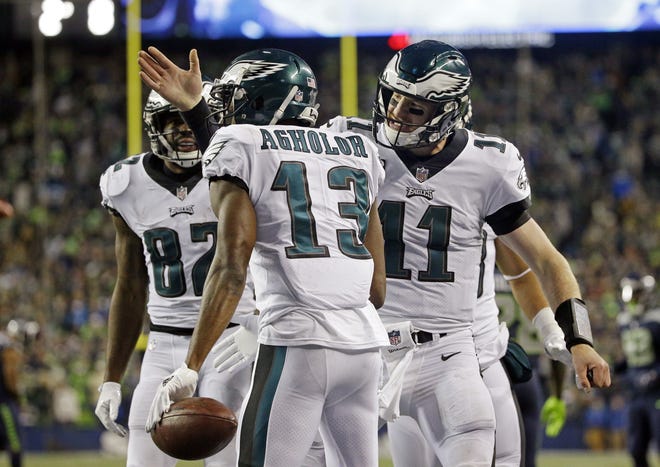 Philadelphia Eagles quarterback Carson Wentz, right, congratulates Nelson Agholor (13) on his touchdown reception against the Seattle Seahawks on Sunday during the second half of a NFL game. [AP Photo/Ted S. Warren]