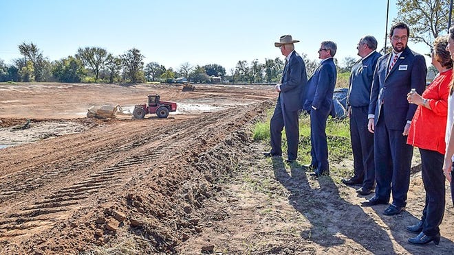 U.S. Rep. Michael McCaul (second from left) views the detention pond being built south of Seventh Street to alleviate flooding to the residential area. From left are Bastrop County Judge Paul Pape, McCaul, City Manager Robert Tamble, Mayor Scott Saunders and Precinct 2 County Commissioner Clara Beckett. FRAN HUNTER FOR SMITHVILLE TIMES