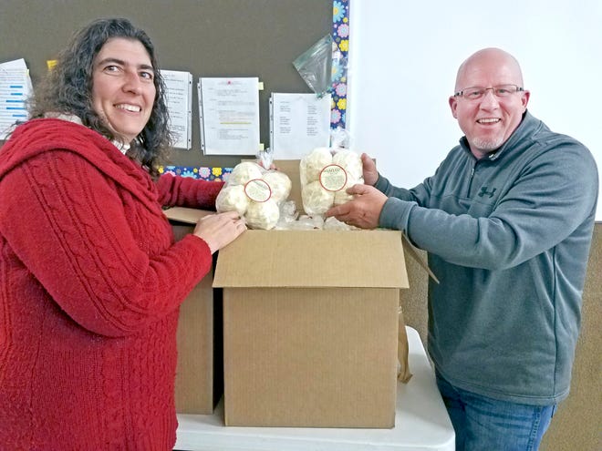 The Creston Lions Club is having its annual Popcorn Ball Sale. They may be purchased from any Creston Lion or the following mertchants: Creston Insurance Agency, Coffey Insurance, Helens, W.G. Dairy, Pike Station, Canaan Meats, Serling Cut and Curl and in wooster at the Butcher Block. A four pack costs $3. For more information please call 330-435-6704. New member Monica Trapp and Kurt Manges pose with some of the popcorn balls.