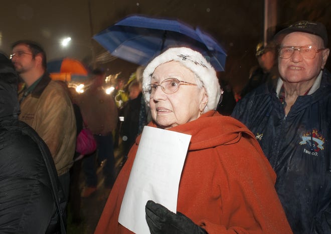 Cynthia Worthington, of Bensalem, listens as names of police officers killed in the line of duty are spoken during the 17th annual Project Blue Light Holiday Tree Lighting ceremony Tuesday at the Lower Southampton Library in Lower Southampton. [William Thomas Cain/Photojournalist]
