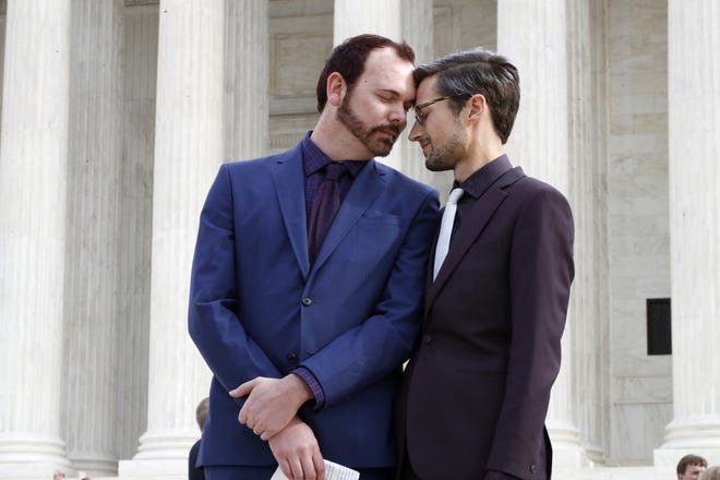 Charlie Craig, left, and David Mullins touch foreheads after leaving the Supreme Court which is hearing the case, the 'Masterpiece Cakeshop v. Colorado Civil Rights Commission' today, Tuesday, Dec. 5, 2017, in Washington. (AP Photo/Jacquelyn Martin)