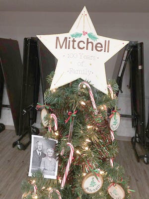A celebratory Christmas tree was on display during the Mitchell family’s 100th annual holiday dinner. Pictured on the tree are David and Margaret Mitchell whose 11 children’s families have carried on the tradition of gathering for a holiday feast at the Bruce Township Hall each year.
