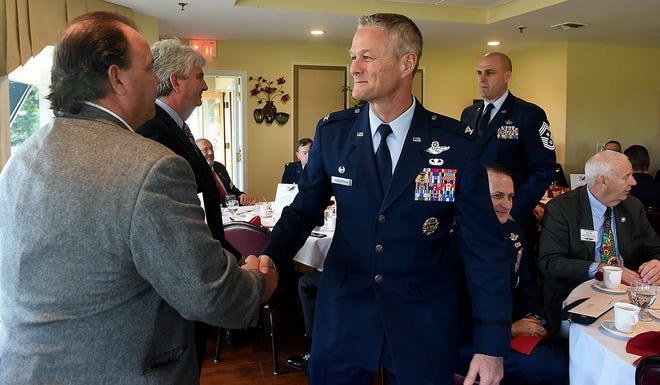 Michael Giletto (left), of Mount Laurel, president of the Burlington County Military Affairs Committee, shakes hands with Air Force Col. Chuck Henderson, of the 621st Contingency Dispersing Wing at Joint Base-McGuire-Dix-Lakehurst, after his wing received a check from the committee during the annual holiday leadership luncheon in Westampton on Wednesday, Dec. 6, 2017. [NANCY ROKOS / STAFF PHOTOJOURNALIST]