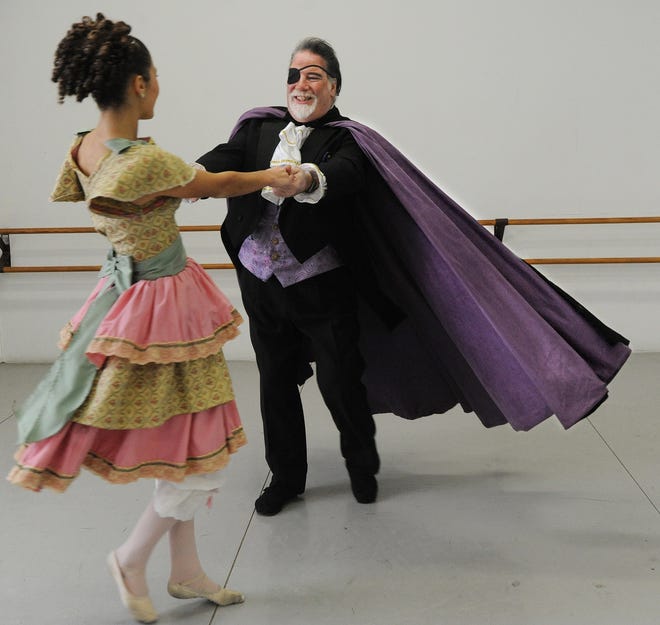 Playing the part of "Drosselmeyer", Eddie Camara rehearses for his 20th Spindle City Ballet annual production of "The Nutcracker". He twirls Cami Parker, 14, in her role as "Clara". [Herald News Photo | Jack Foley]